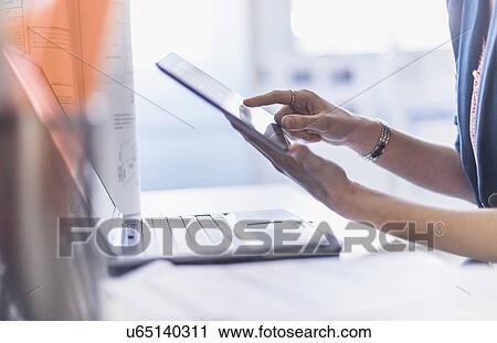 Stock Image - Close up of hands holding digital tablet. Fotosearch