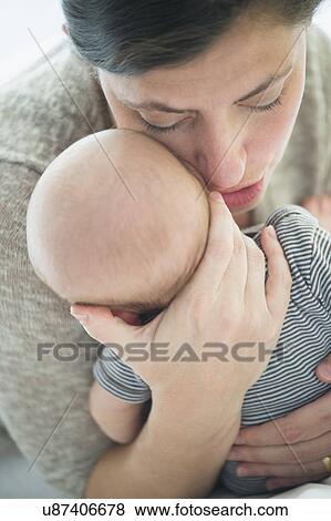 Close up of mother whispering into baby boy's(2-5 months) ear View Large Photo Image Stock Photo - Close up of mother whispering into baby boy's(2-5 months) ear. Fotosearch