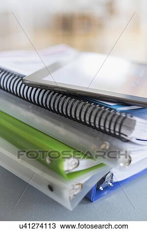 Close up of stack of notebooks with digital tablet on top View Large Photo Image Stock Image - Close up of stack of notebooks with digital tablet on top. Fotosearch