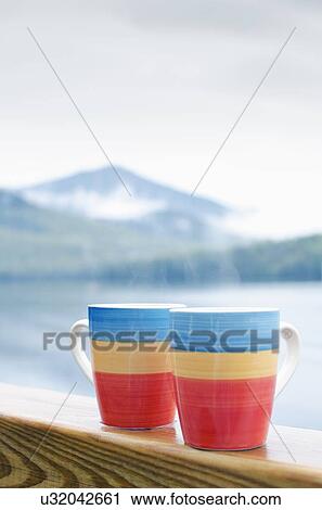 Coffee mugs on railing View Large Photo Image Stock Image - Coffee mugs on railing. Fotosearch