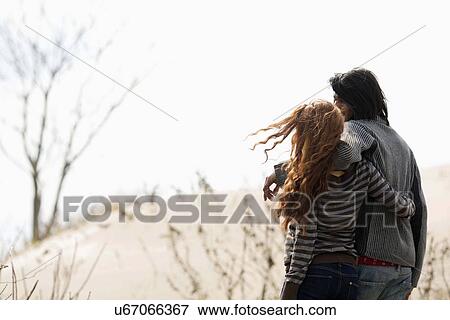 Couple embracing outdoors View Large Photo Image Stock Photo - Couple embracing outdoors. Fotosearch