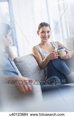 Couple relaxing on sofa View Large Photo Image Picture - Couple relaxing on sofa. Fotosearch