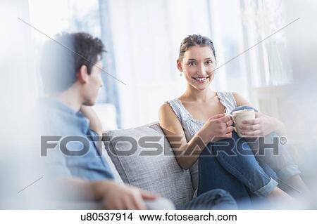Couple relaxing on sofa View Large Photo Image Picture - Couple relaxing on sofa. Fotosearch
