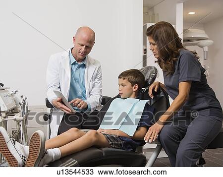 Dentist holding digital tablet with patient's( 12-13) x-ray View Large Photo Image Stock Image - Dentist holding digital tablet with patient's( 12-13) x-ray. Fotosearch