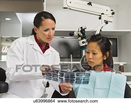 Dentist holding patient's x-ray View Large Photo Image Picture - Dentist holding patient's x-ray. Fotosearch
