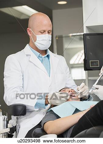 Stock Photo - Dentist operation on patient. Fotosearch