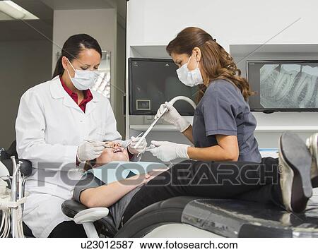 Dentist operation on patient View Large Photo Image Stock Photo - Dentist operation on patient. Fotosearch