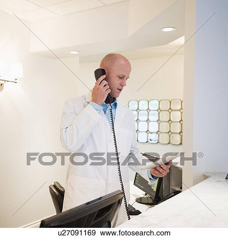 Stock Photo - Doctor talking on phone. Fotosearch