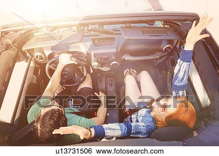 Elevated view of couple in car View Large Photo Image Stock Photograph - Elevated view of couple in car. Fotosearch