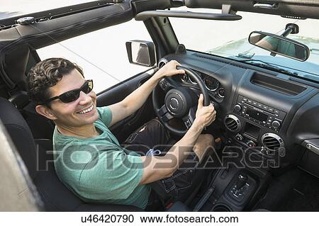 Stock Image - Elevated view of man driving car. Fotosearch