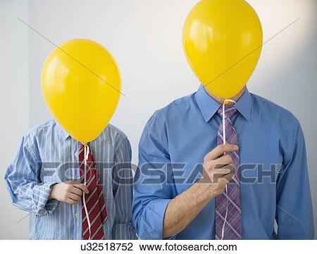 Father and son (8-9) holding yellow balloons View Large Photo Image Stock Image - Father and son (8-9) holding yellow balloons. Fotosearch