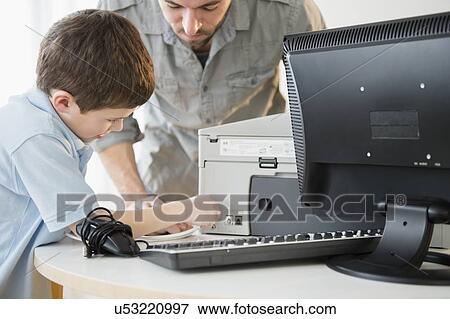 Father and son (8-9) setting up printer with computer on table View Large Photo Image Stock Photo - Father and son (8-9) setting up printer with computer on table. Fotosearch