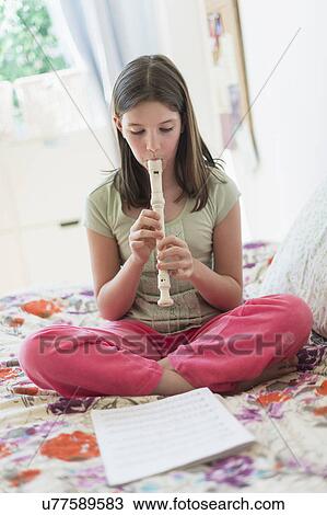 girl (10-11) playing flute View Large Photo Image Stock Image - girl (10-11) playing flute. Fotosearch
