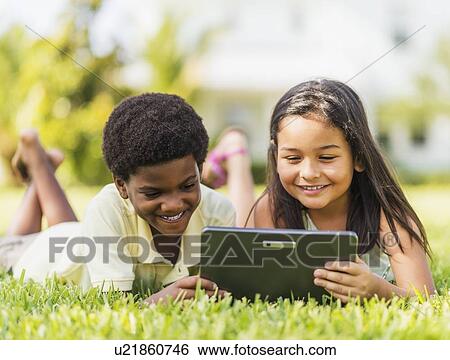 girl ( 8-9) and boy (6-7) using digital tablet View Large Photo Image Stock Photograph - girl ( 8-9) and boy (6-7) using digital tablet. Fotosearch