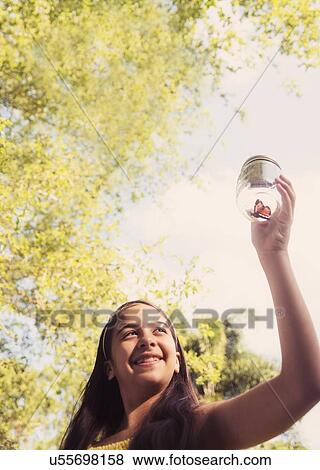 girl ( 8-9) holding jar with butterfly View Large Photo Image Stock Photo - girl ( 8-9) holding jar with butterfly. Fotosearch