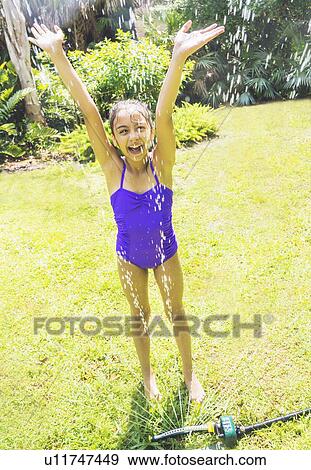 girl (8-9) playing in sprinkler View Large Photo Image Stock Photo - girl (8-9) playing in sprinkler. Fotosearch