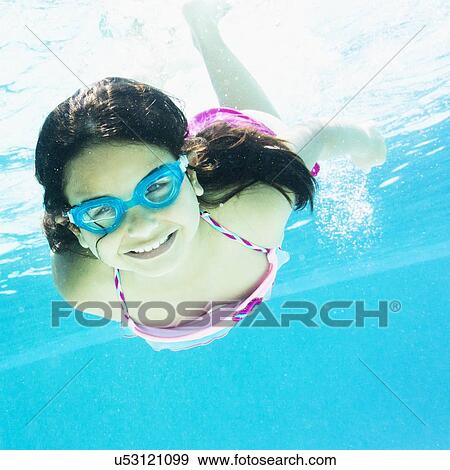 Stock Photo - girl ( 8-9) swimming. Fotosearch