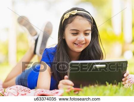 girl ( 8-9) using digital tablet View Large Photo Image Stock Photography - girl ( 8-9) using digital tablet . Fotosearch