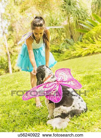 girl (8-9) wearing fairy costume playing with dog View Large Photo Image Stock Image - girl (8-9) wearing fairy costume playing with dog. Fotosearch