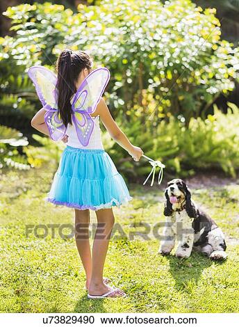 girl (8-9) wearing fairy costume playing with dog View Large Photo Image Stock Image - girl (8-9) wearing fairy costume playing with dog. Fotosearch