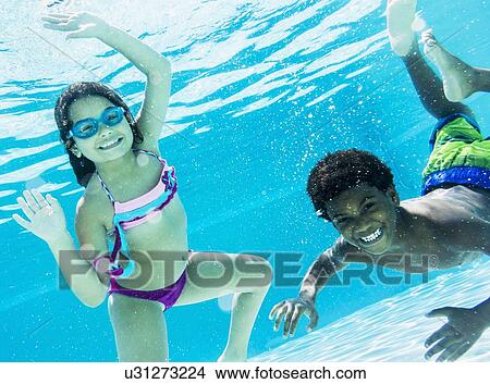 Girl and boy ( 6-7, 8-9) swimming View Large Photo Image Picture - Girl and boy ( 6-7, 8-9) swimming. Fotosearch