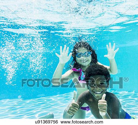 Girl and boy ( 6-7, 8-9) swimming View Large Photo Image Stock Photograph - Girl and boy ( 6-7, 8-9) swimming. Fotosearch