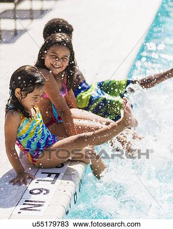 Girls(4-5, 8-9) and boy (6-7) playing on swimming pool View Large Photo Image Stock Image - Girls(4-5, 8-9) and boy (6-7) playing on swimming pool. Fotosearch