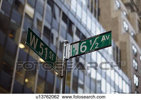 Stock Image - Low angle view of street name sign . Fotosearch
