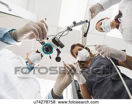 Lowe angle view of dentists and assistant View Large Photo Image Stock Photo - Lowe angle view of dentists and assistant. Fotosearch
