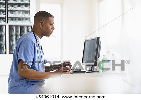 Male doctor in hospital using digital tablet View Large Photo Image Picture - Male doctor in hospital using digital tablet. Fotosearch