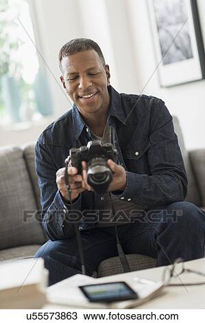 Man holding digital camera View Large Photo Image Stock Image - Man holding digital camera. Fotosearch