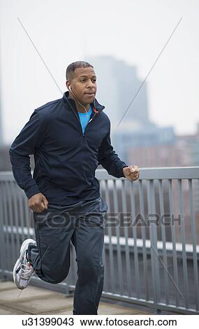 Stock Image - Man running in city. Fotosearch