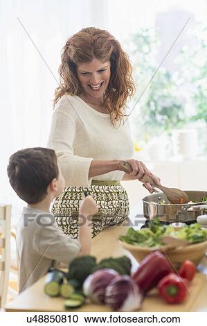 Mother and son (6-7) cooking together View Large Photo Image Stock Image - Mother and son (6-7) cooking together. Fotosearch