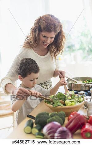 Mother and son (6-7) cooking together View Large Photo Image Stock Photography - Mother and son (6-7) cooking together. Fotosearch