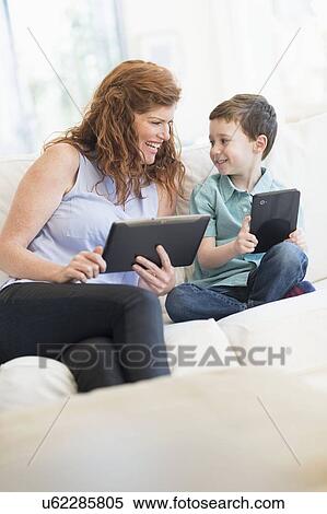 Mother and son (6-7) using digital tablets View Large Photo Image Stock Photography - Mother and son (6-7) using digital tablets. Fotosearch