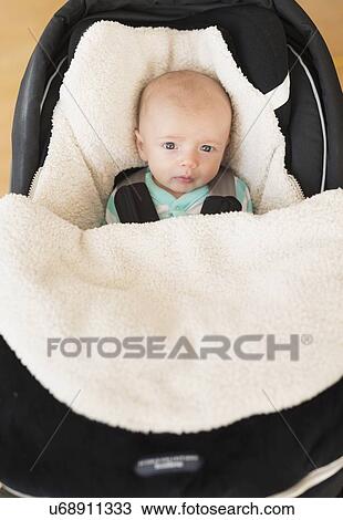 Portrait of baby boy (2-5 months) sitting in stroller View Large Photo Image Stock Image - Portrait of baby boy (2-5 months) sitting in stroller. Fotosearch