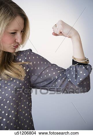 Picture - Portrait of blond woman showing muscle. Fotosearch