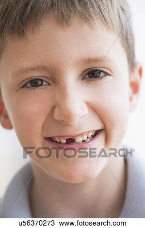 Stock Image - Portrait of boy (8-9) smiling. Fotosearch