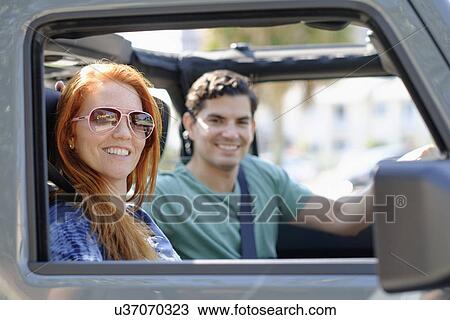 Portrait of couple sitting in car View Large Photo Image Stock Image - Portrait of couple sitting in car. Fotosearch