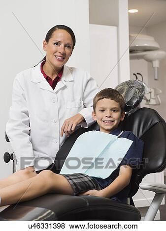 Stock Photo - Portrait of dentist with patient( 12-13). Fotosearch