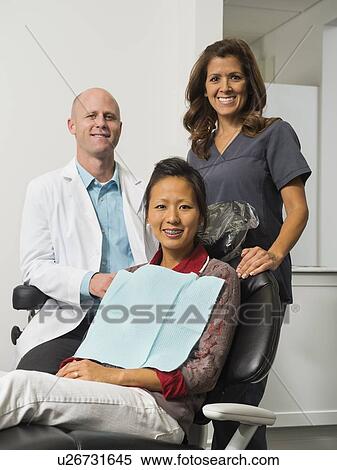 Portrait of dentist with patient and assistant View Large Photo Image Stock Photography - Portrait of dentist with patient and assistant. Fotosearch