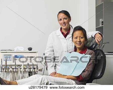 Stock Photo - Portrait of dentist with patient. Fotosearch