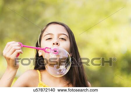 Portrait of girl (8-9) blowing bubbles View Large Photo Image Stock Image - Portrait of girl (8-9) blowing bubbles. Fotosearch