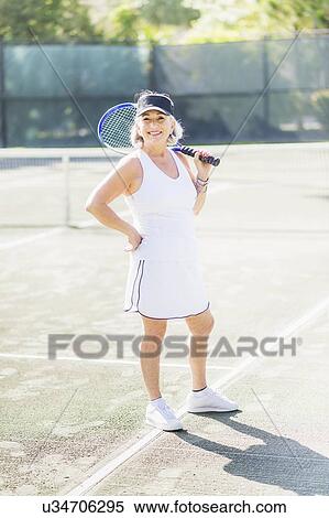 Portrait of senior woman on tennis court View Large Photo Image Stock Photography - Portrait of senior woman on tennis court. Fotosearch
