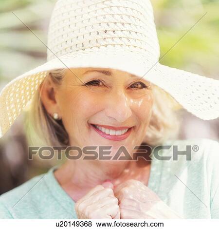 Stock Photo - Portrait of senior woman wearing sunhat. Fotosearch