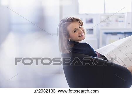 Portrait of smiling business woman in office View Large Photo Image Stock Image - Portrait of smiling business woman in office. Fotosearch