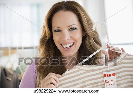 Picture - Portrait of woman doing clothes shopping. Fotosearch