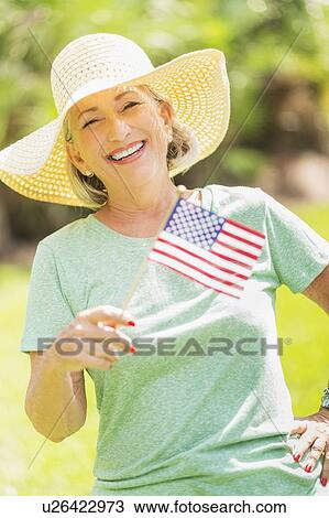Portrait of woman holding american flag View Large Photo Image Stock Image - Portrait of woman holding american flag. Fotosearch