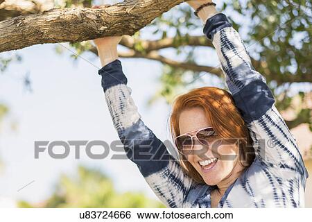 Stock Photograph - Portrait of woman holding branch. Fotosearch