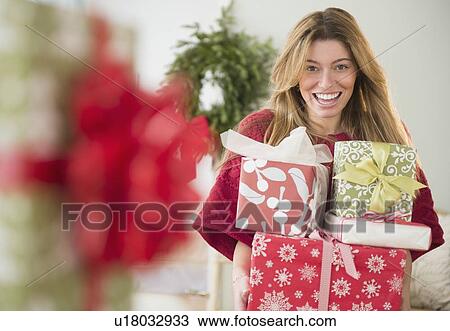 Portrait of woman holding christmas presents View Large Photo Image Stock Image - Portrait of woman holding christmas presents. Fotosearch
